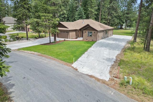 231 Hogans Way, Chewelah, WA 99109 - view of front of house with concrete driveway, an attached garage, and a front lawn