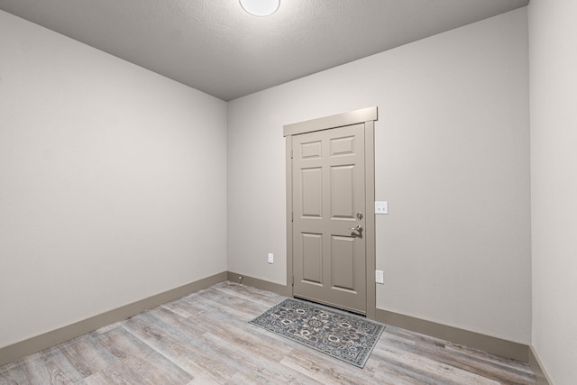 231 Hogans Way, Chewelah, WA 99109 - foyer entrance with light wood-type flooring and a textured ceiling