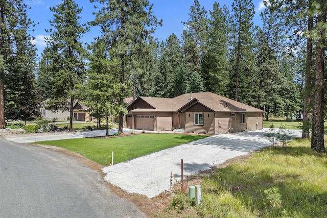 231 Hogans Way, Chewelah, WA 99109 - rustic home featuring driveway, an attached garage, and a front yard