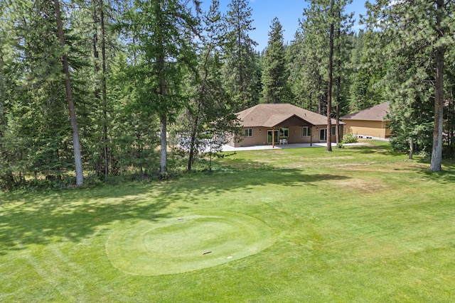 231 Hogans Way, Chewelah, WA 99109 - view of green lawn with a patio area, a putting green, and a wooded view