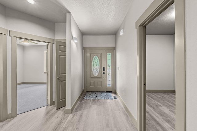 231 Hogans Way, Chewelah, WA 99109 - entryway with light wood-style flooring, a textured ceiling, and ceiling fan