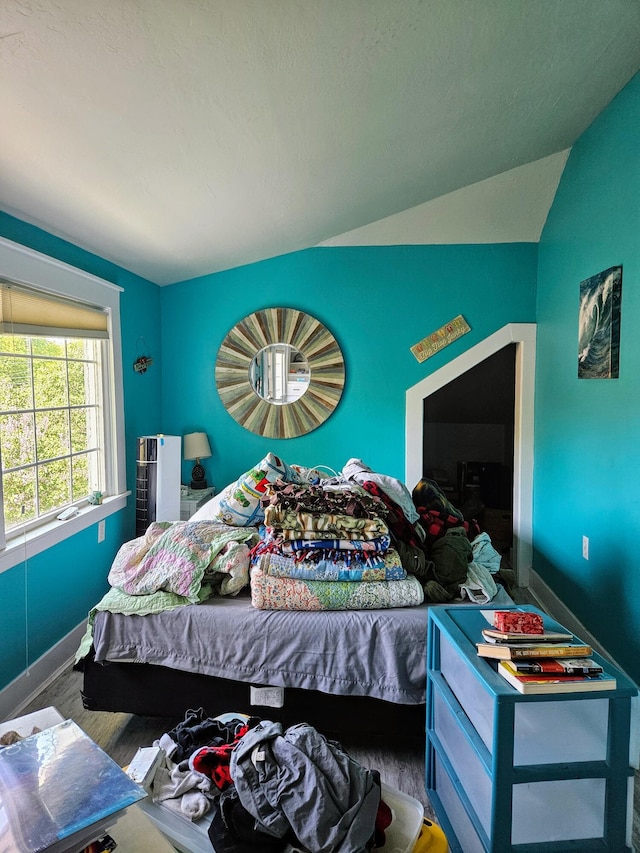 453 E Astor Ave, Colville, WA 99114 - bedroom featuring vaulted ceiling, baseboards, and wood finished floors