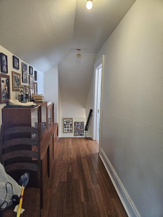 453 E Astor Ave, Colville, WA 99114 - corridor with lofted ceiling, baseboards, an upstairs landing, and wood finished floors