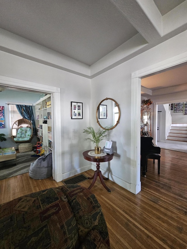 453 E Astor Ave, Colville, WA 99114 - hall with wood finished floors, a tray ceiling, visible vents, baseboards, and stairs