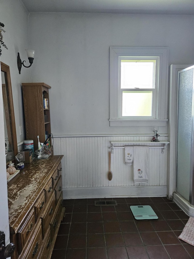 453 E Astor Ave, Colville, WA 99114 - full bathroom featuring a wainscoted wall, vanity, visible vents, tile patterned flooring, and a shower stall