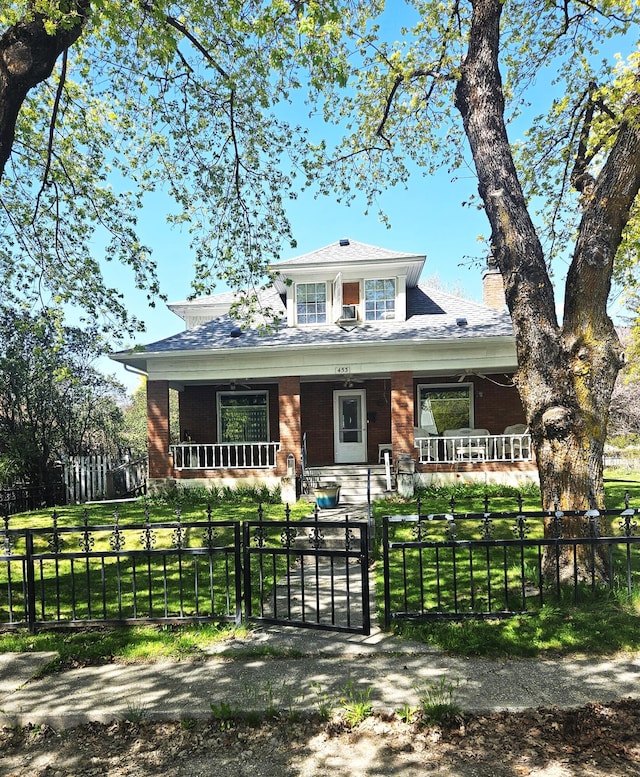 453 E Astor Ave, Colville, WA 99114 - bungalow featuring a chimney, a porch, a fenced front yard, and a gate