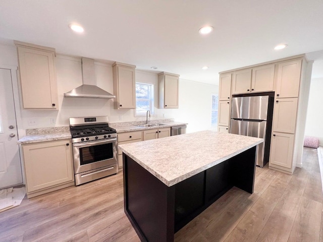 1388 Ponderosa Way, Kettle Falls, WA 99141 - kitchen featuring stainless steel appliances, light countertops, wall chimney range hood, a sink, and light wood-type flooring