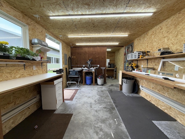 49 Sandpiper Way, Republic, WA 99166 - miscellaneous room featuring a desk, a baseboard heating unit, healthy amount of natural light, and a workshop area