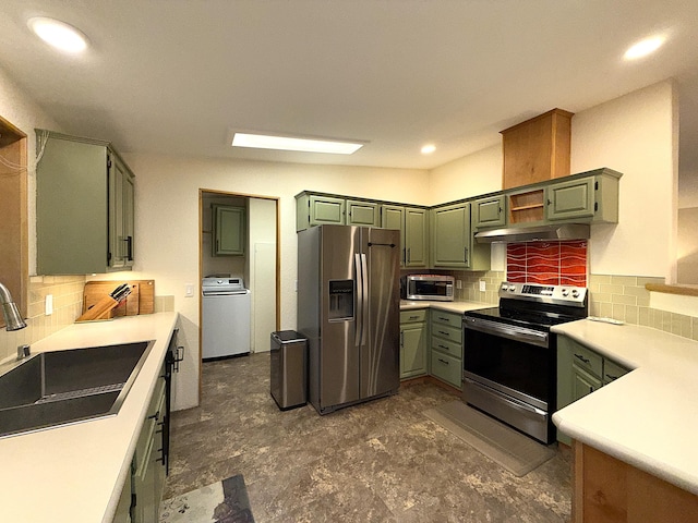 49 Sandpiper Way, Republic, WA 99166 - kitchen featuring stainless steel appliances, washer / dryer, a sink, decorative backsplash, and light countertops