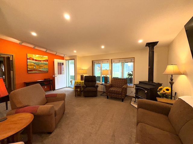 49 Sandpiper Way, Republic, WA 99166 - carpeted living area featuring recessed lighting, a wood stove, and rail lighting
