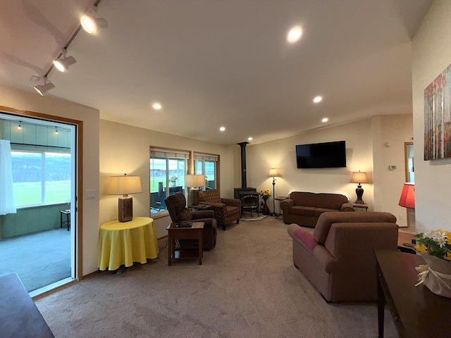 49 Sandpiper Way, Republic, WA 99166 - carpeted living area featuring a wood stove, recessed lighting, track lighting, and vaulted ceiling