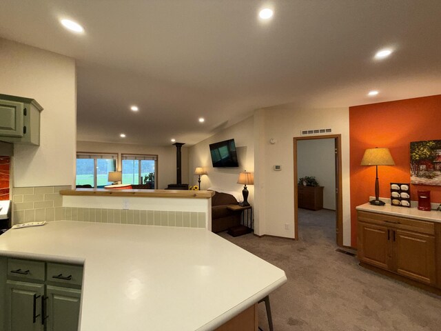 49 Sandpiper Way, Republic, WA 99166 - kitchen featuring recessed lighting, light colored carpet, light countertops, a peninsula, and backsplash