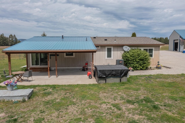 40009 N Sherman Rd, Deer Park, WA 99006 - back of property featuring a yard, a patio area, and metal roof