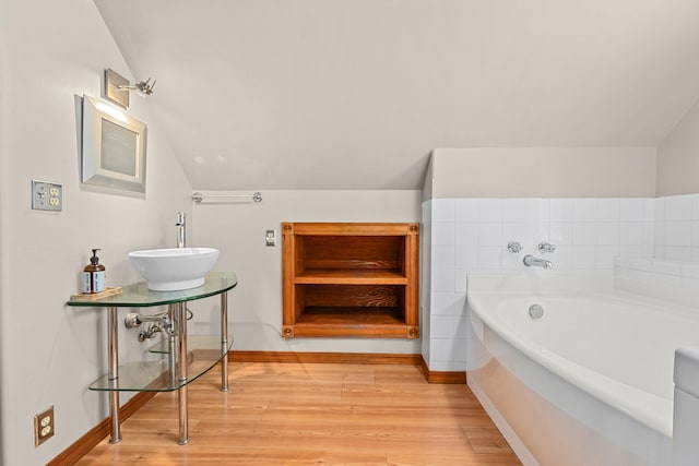 2184 Clugston Onion Creek Rd, Colville, WA 99114 - bathroom featuring a bath, lofted ceiling, and wood finished floors