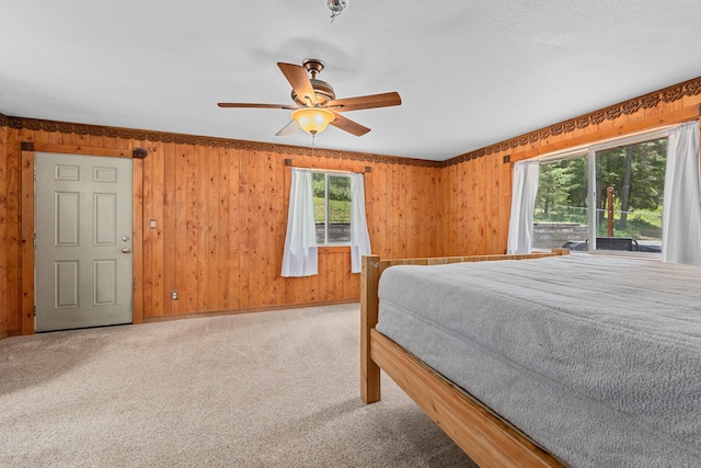 2184 Clugston Onion Creek Rd, Colville, WA 99114 - carpeted bedroom featuring multiple windows, wooden walls, and a ceiling fan