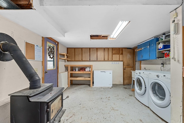 2184 Clugston Onion Creek Rd, Colville, WA 99114 - laundry area with a wood stove and washing machine and clothes dryer