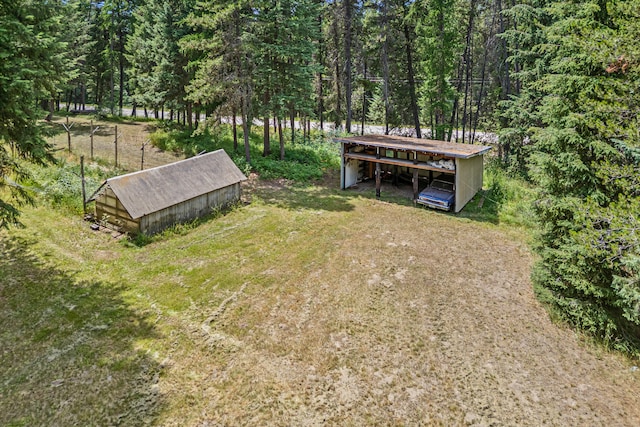 2184 Clugston Onion Creek Rd, Colville, WA 99114 - view of yard featuring an outbuilding, a detached carport, and a forest view