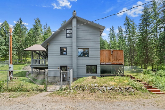 2184 Clugston Onion Creek Rd, Colville, WA 99114 - view of property exterior featuring a gate, a deck, and a chimney
