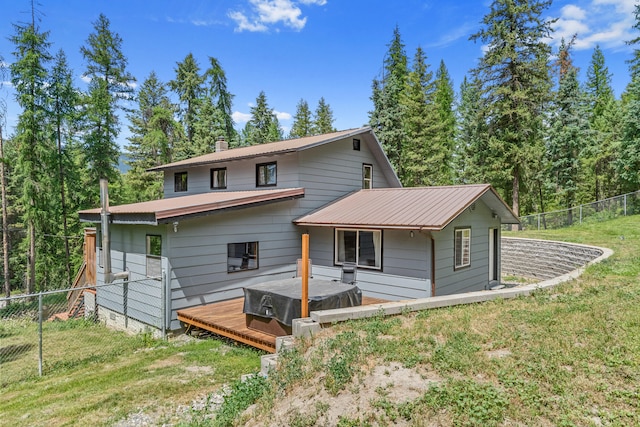2184 Clugston Onion Creek Rd, Colville, WA 99114 - back of house with a fenced backyard, a deck, and a chimney