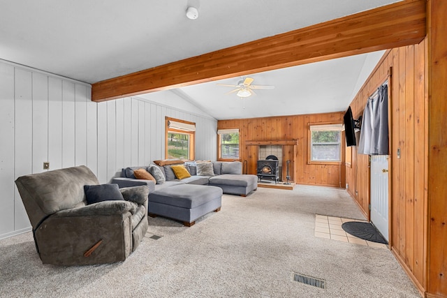 2184 Clugston Onion Creek Rd, Colville, WA 99114 - living room featuring carpet flooring, a wood stove, wood walls, and ceiling fan