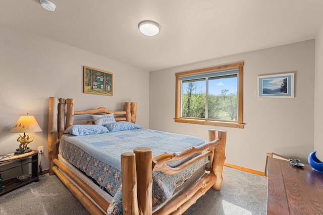 bedroom with baseboards and carpet