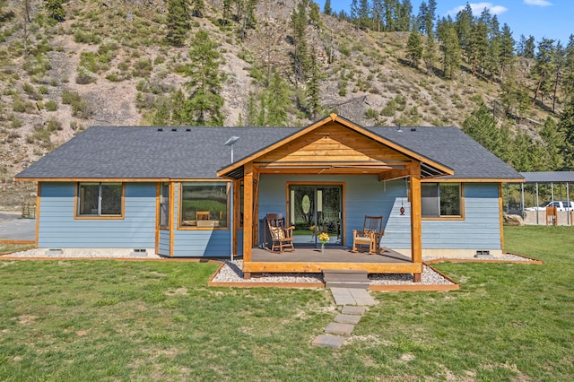 back of house featuring a yard, crawl space, a shingled roof, and a deck