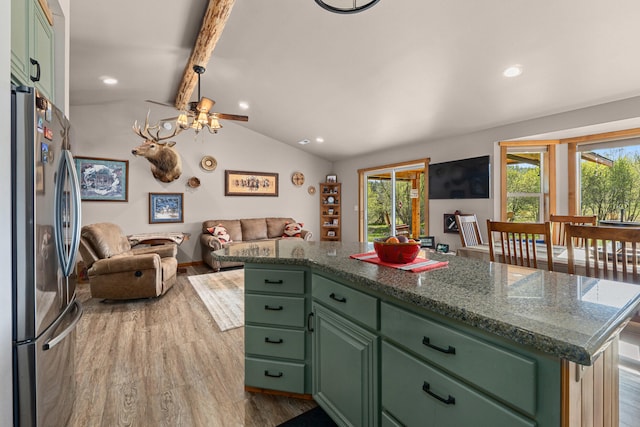 kitchen with green cabinetry, freestanding refrigerator, open floor plan, vaulted ceiling with beams, and wood finished floors