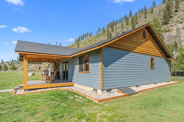 view of home's exterior featuring a lawn and a wooden deck