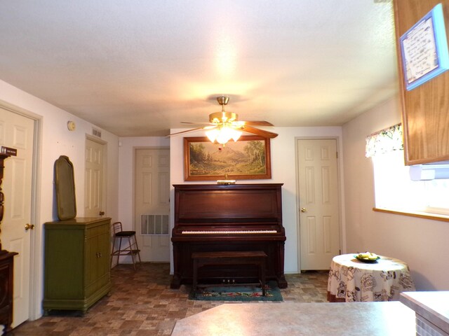 sitting room featuring visible vents and ceiling fan