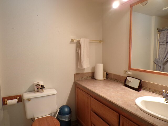 full bath featuring toilet and vanity