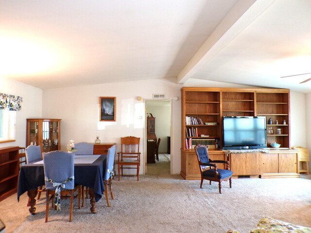 carpeted dining space with visible vents, a ceiling fan, and vaulted ceiling with beams