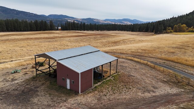 exterior space featuring a rural view and a view of trees