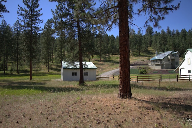 1425 Chapin Rd N, Evans, WA 99126 - view of yard featuring an outdoor structure and a view of trees