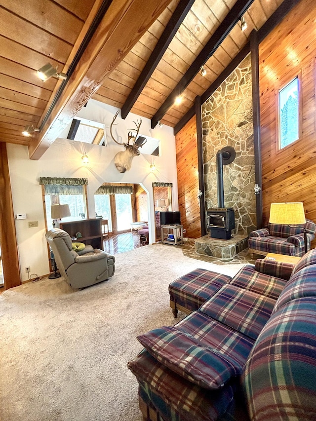 1425 Chapin Rd N, Evans, WA 99126 - carpeted living room with a wood stove, a wooden ceiling with exposed beams, wood walls, and high vaulted ceiling