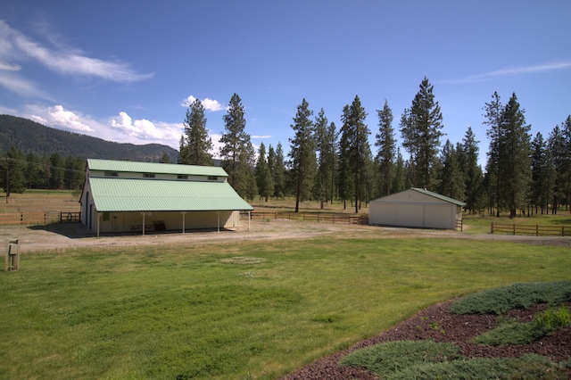1425 Chapin Rd N, Evans, WA 99126 - view of grassy yard featuring an outbuilding, an exterior structure, a mountain view, and a view of rural / pastoral area