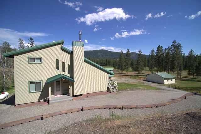 1425 Chapin Rd N, Evans, WA 99126 - back of house featuring a chimney and a mountain view