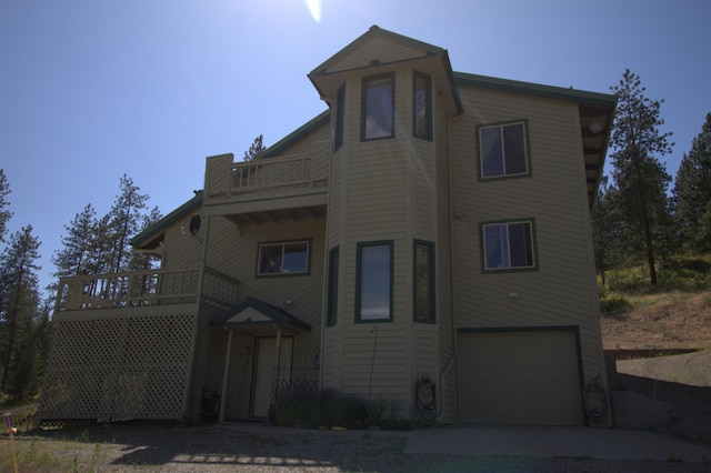 1425 Chapin Rd N, Evans, WA 99126 - view of front of house featuring a balcony, driveway, and an attached garage