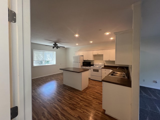 360 E 7th Ave, Colville, WA 99114 - kitchen featuring white appliances, dark countertops, a kitchen island, recessed lighting, and white cabinets