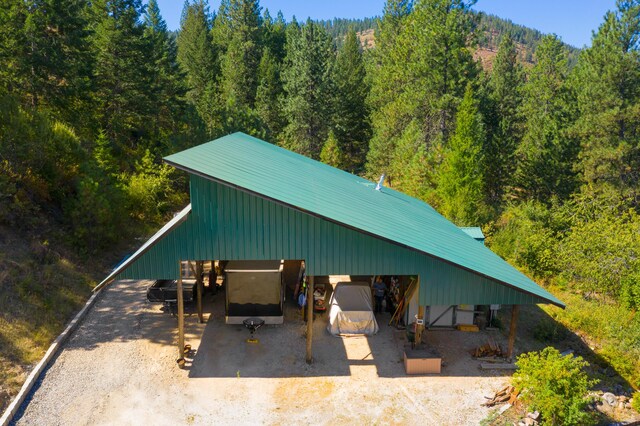 2751 Rathbun Way, Chewelah, WA 99109 - exterior space featuring a carport, a forest view, and driveway