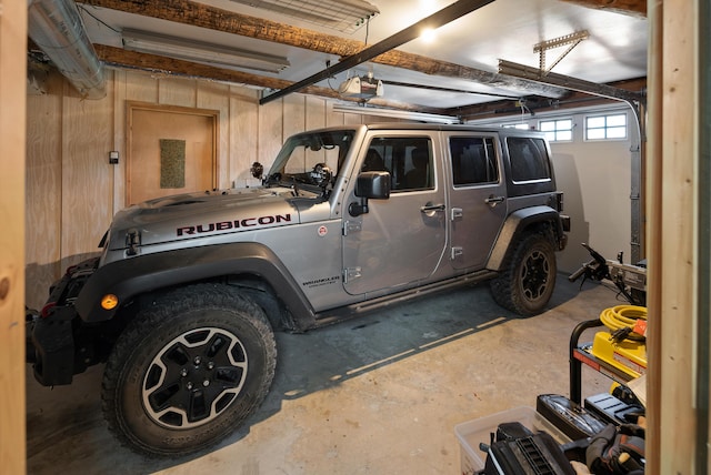 2751 Rathbun Way, Chewelah, WA 99109 - garage featuring a garage door opener and wood walls