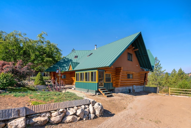 2751 Rathbun Way, Chewelah, WA 99109 - rear view of property featuring a standing seam roof, log siding, fence, and metal roof