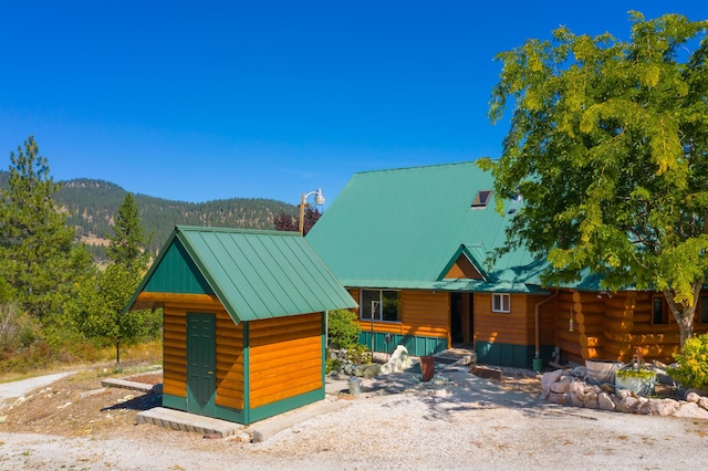 2751 Rathbun Way, Chewelah, WA 99109 - view of front of home featuring a mountain view, metal roof, and an outdoor structure