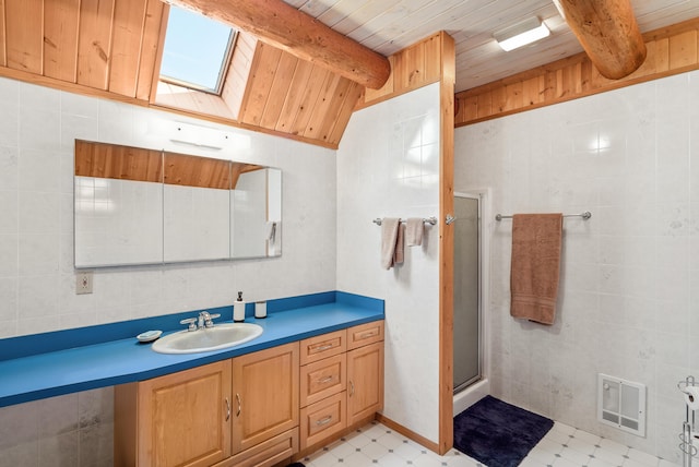2751 Rathbun Way, Chewelah, WA 99109 - full bath with tile patterned floors, visible vents, tile walls, and lofted ceiling with beams