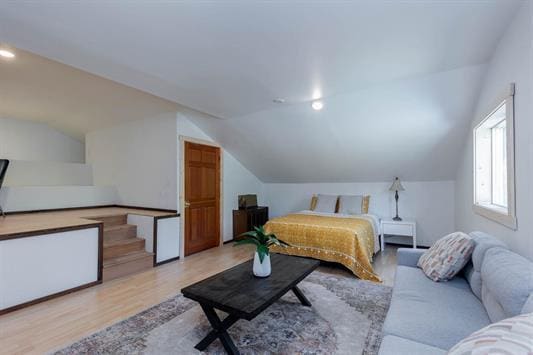 bedroom featuring vaulted ceiling and wood finished floors