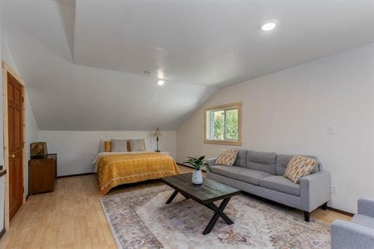 bedroom featuring lofted ceiling, light wood-style flooring, and recessed lighting