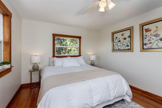 bedroom with wood finished floors, a ceiling fan, and baseboards