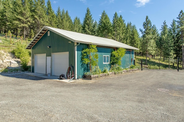 detached garage featuring a gate