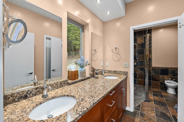 full bath with a bidet, a sink, a tile shower, and double vanity