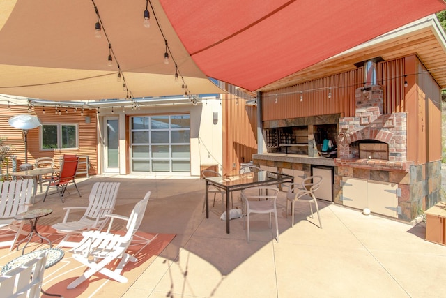 view of patio / terrace with outdoor dining space and exterior fireplace