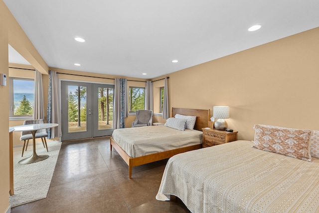 bedroom featuring finished concrete flooring, french doors, recessed lighting, and access to exterior